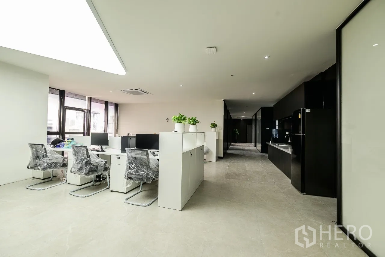 Office Space for rent or sale in Huai Khwang, Bangkok - Work zone with desks beside a pantry and corridor in a modern office.