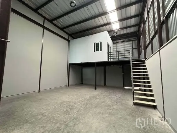 Warehouse for rent in Bang Phli, Samut Prakan - High-ceiling warehouse bay with steel structure, mezzanine office, and stair access.