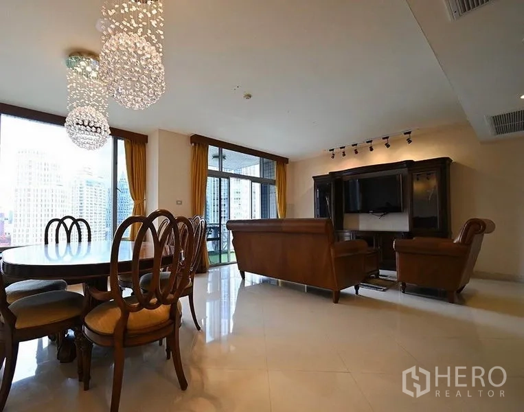 Condominium for rent in Pathum Wan, Bangkok - Open-plan lounge and dining with city-view windows, balcony access, and a large media cabinet.