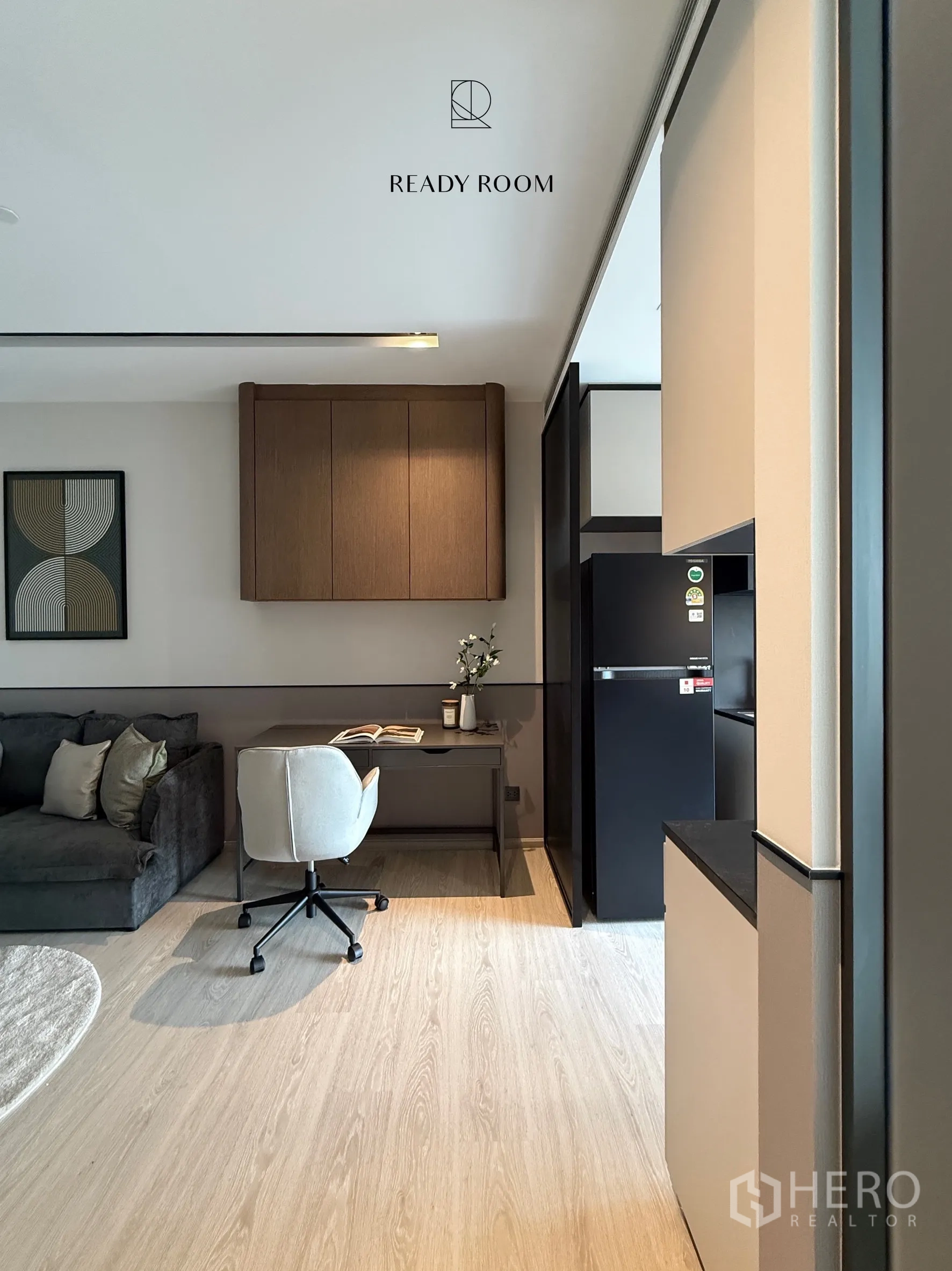Condominium for rent in Khlong Toei, Bangkok - Sofa, workspace, and refrigerator in a contemporary condo interior.