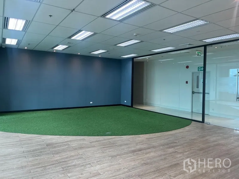 Office Space for rent in Chatuchak, Bangkok - Collaboration room featuring an artificial grass circle, blue feature wall and a glass door.