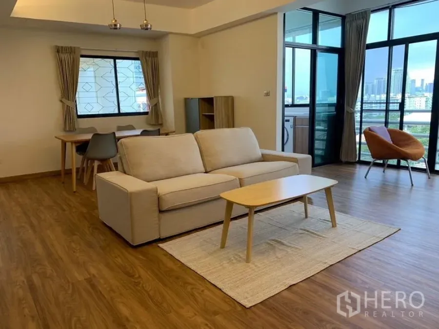 Condominium for rent - Open-plan living and dining area with balcony access and city outlook.