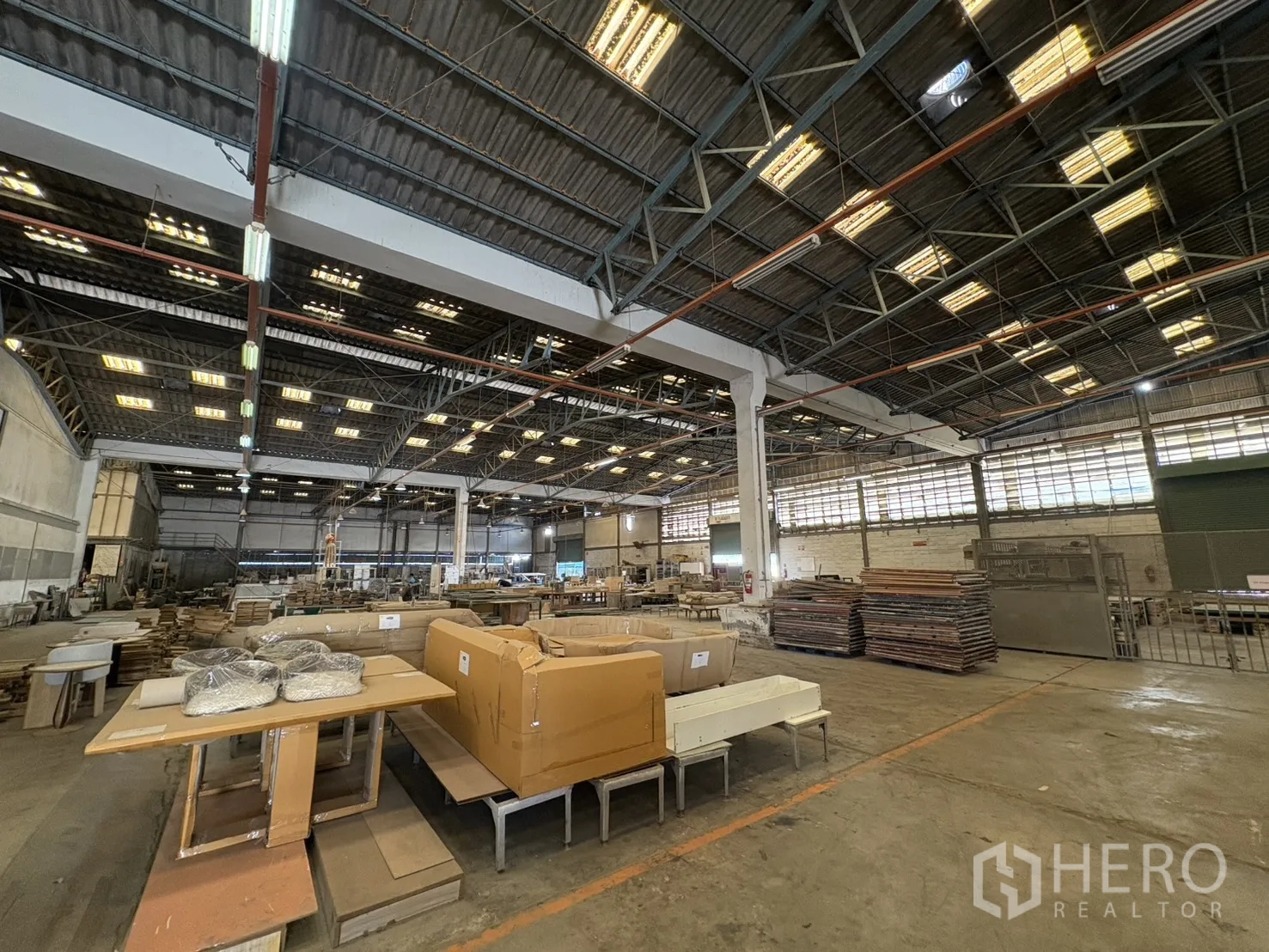 Factory for sale in Khlong Toei, Bangkok - Packing area with stacked panels and boxed goods