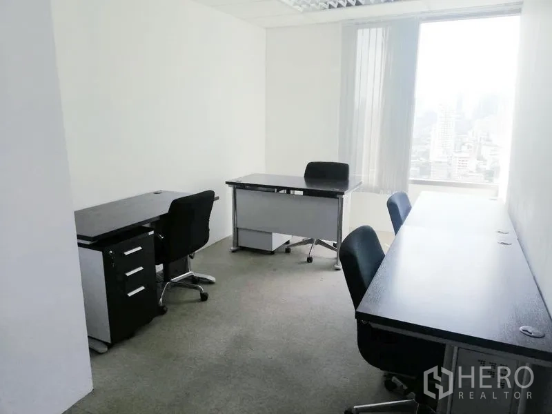 Office Space for rent in Ratchathewi, Bangkok - Compact private office with workstations, task chairs and a window showcasing a city view.