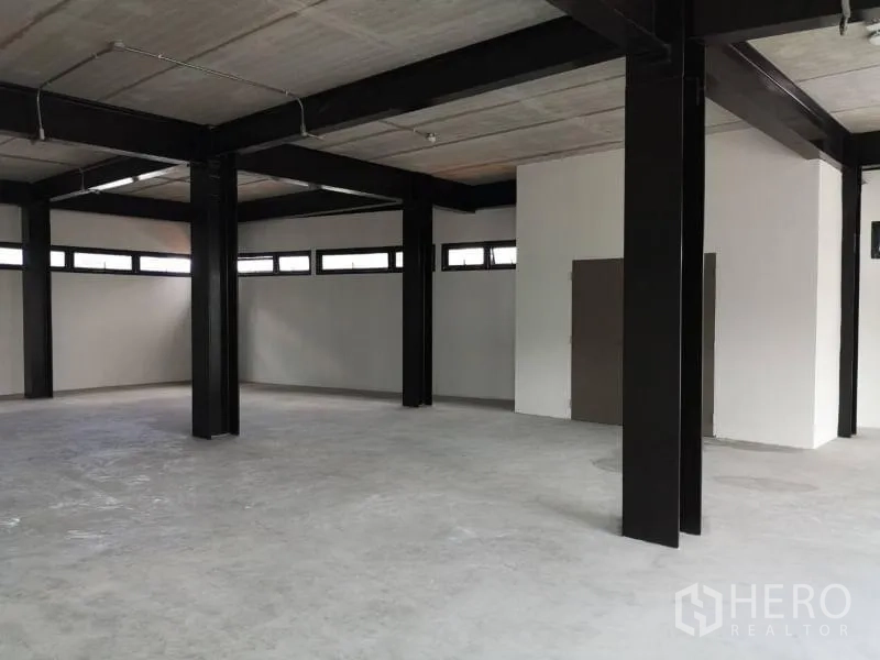 Office Space for rent in Chatuchak, Bangkok - Unfurnished workspace with black columns, long high windows and smooth concrete floor.
