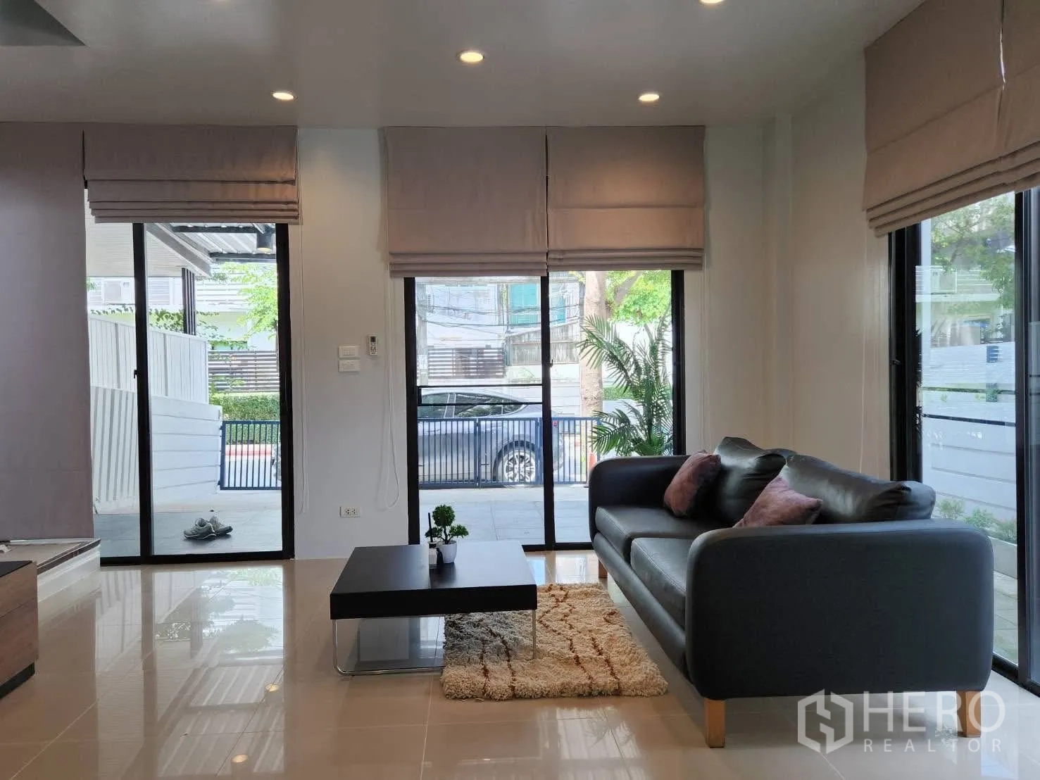 Townhouse for rent in Suan Luang, Bangkok - Bright living room with sofa, coffee table and three sliding doors.