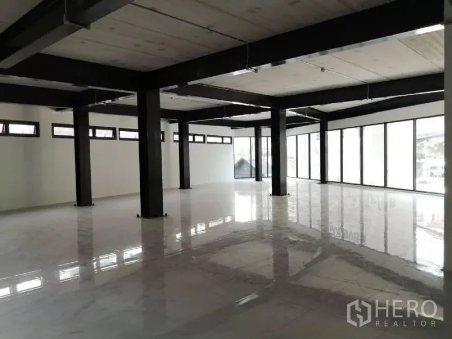 Office Space for rent in Chatuchak, Bangkok - Open‑plan office interior with black steel columns, polished white tile floors and full‑height windows.