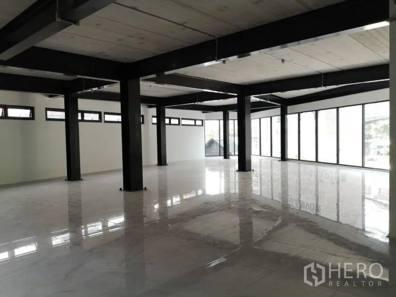 Office Space for rent in Chatuchak, Bangkok - Open‑plan office interior with black steel columns, polished white tile floors and full‑height windows.