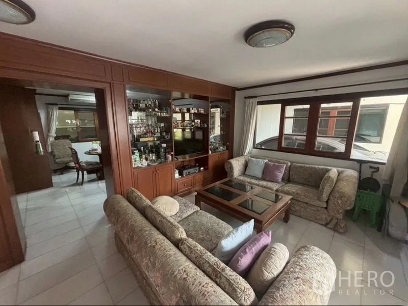 Detached House for sale in Suan Luang, Bangkok - Living room with sofa set, coffee table and built-in display cabinet.