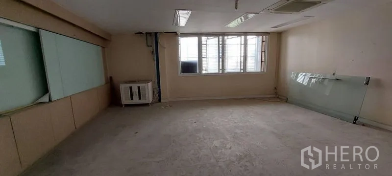 Retail Space for rent - Bright workspace with windows, wall AC unit, and built‑in glass board.