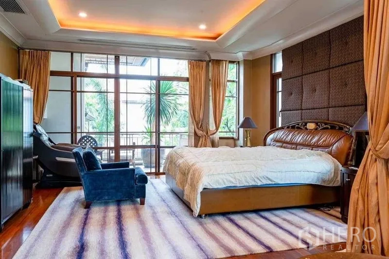 Detached House for sale - Large bedroom with cove lighting, floor-to-ceiling windows and balcony view.