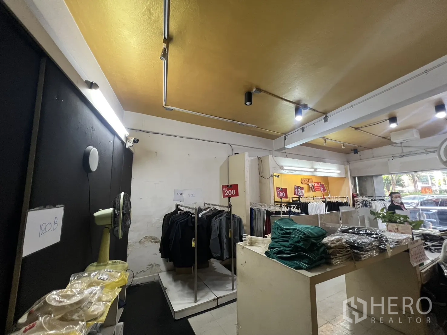 Shophouse for rent - Ground-floor retail area with clothing racks, track lighting and glass frontage.