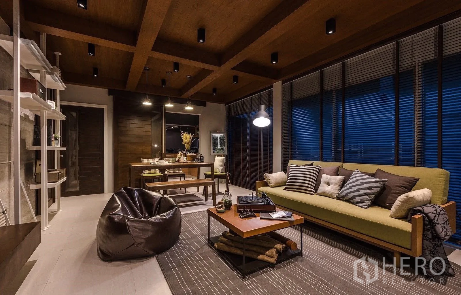 Townhouse for sale in Suan Luang, Bangkok - Open lounge and dining area with beamed ceiling and large windows.