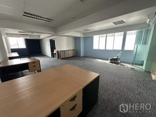 Office Space for rent in Watthana, Bangkok - Bright furnished office showing multiple desks, glass entry and wide windows in a modern workspace.