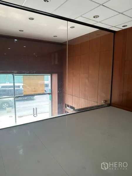 Office Space for rent in Pathum Wan, Bangkok - Glass-walled meeting or private office overlooking the entrance with warm wood wall panels.