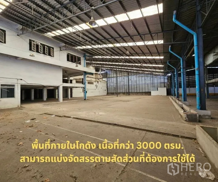 Factory for rent in Bang Kho Laem, Bangkok - Large covered warehouse with steel truss roof and open concrete floor.