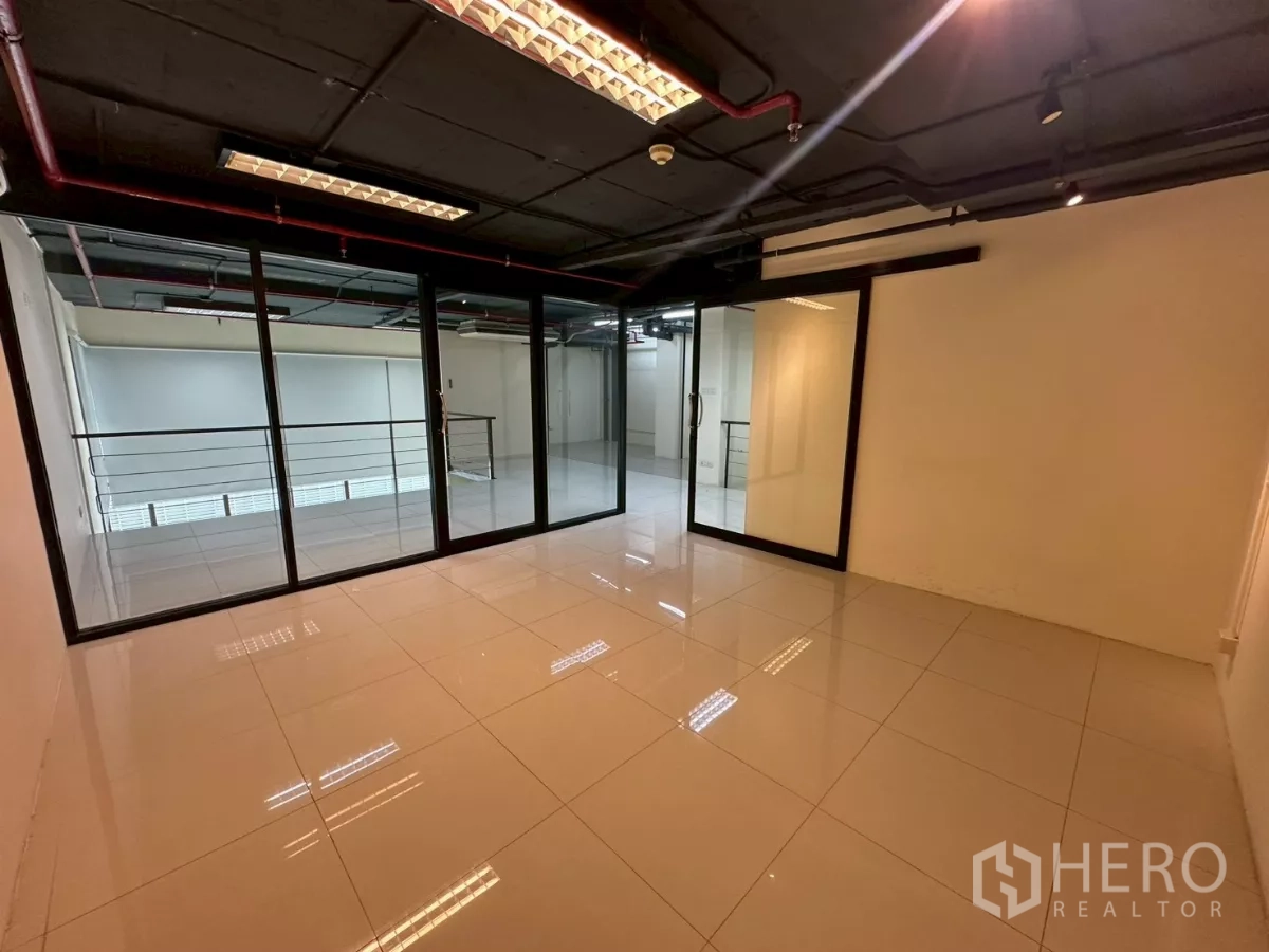 Office Space for rent in Khlong Toei, Bangkok - Inside private meeting room with sliding glass doors and dark exposed ceiling.