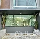 Home Office for rent in Wang Thonglang, Bangkok - Ground-floor glass frontage with planters framing the entrance.