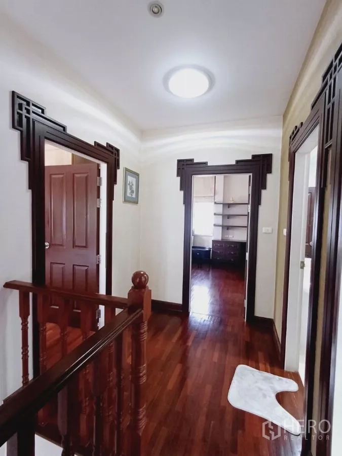 Detached House for rent or sale in Mueang Nonthaburi, Nonthaburi - Upstairs landing and corridor with wooden flooring and ceiling light.