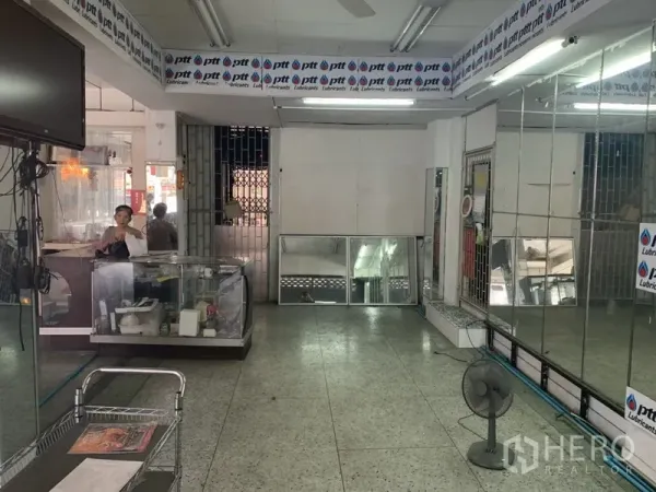 Shophouse for rent in Khlong Toei, Bangkok - Deep shop interior featuring mirrored wall panels, terrazzo flooring and a rear security gate.