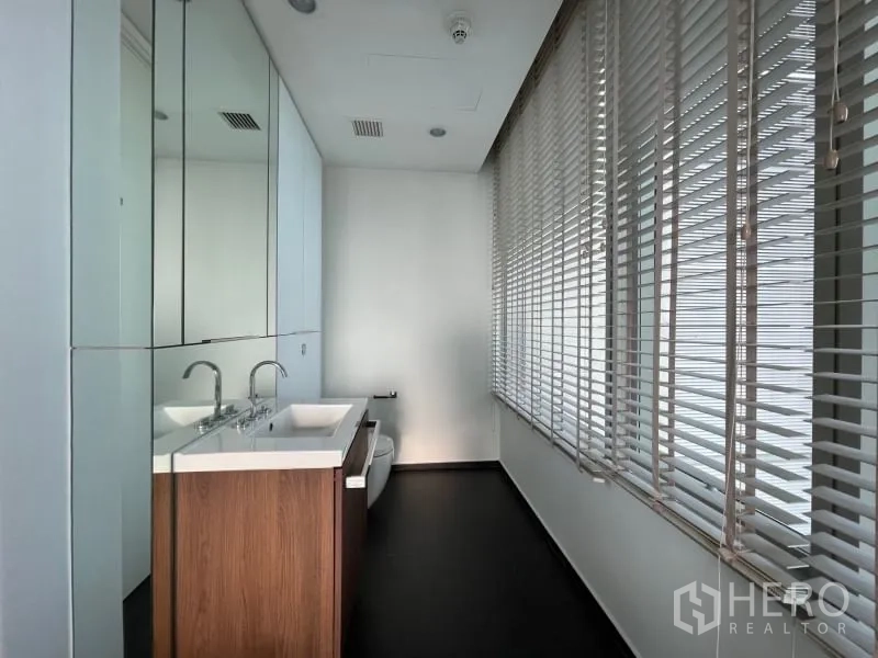Condominium for rent or sale in Pathum Wan, Bangkok - Second bathroom featuring twin sinks, long vanity, full-height mirrors and window blinds.