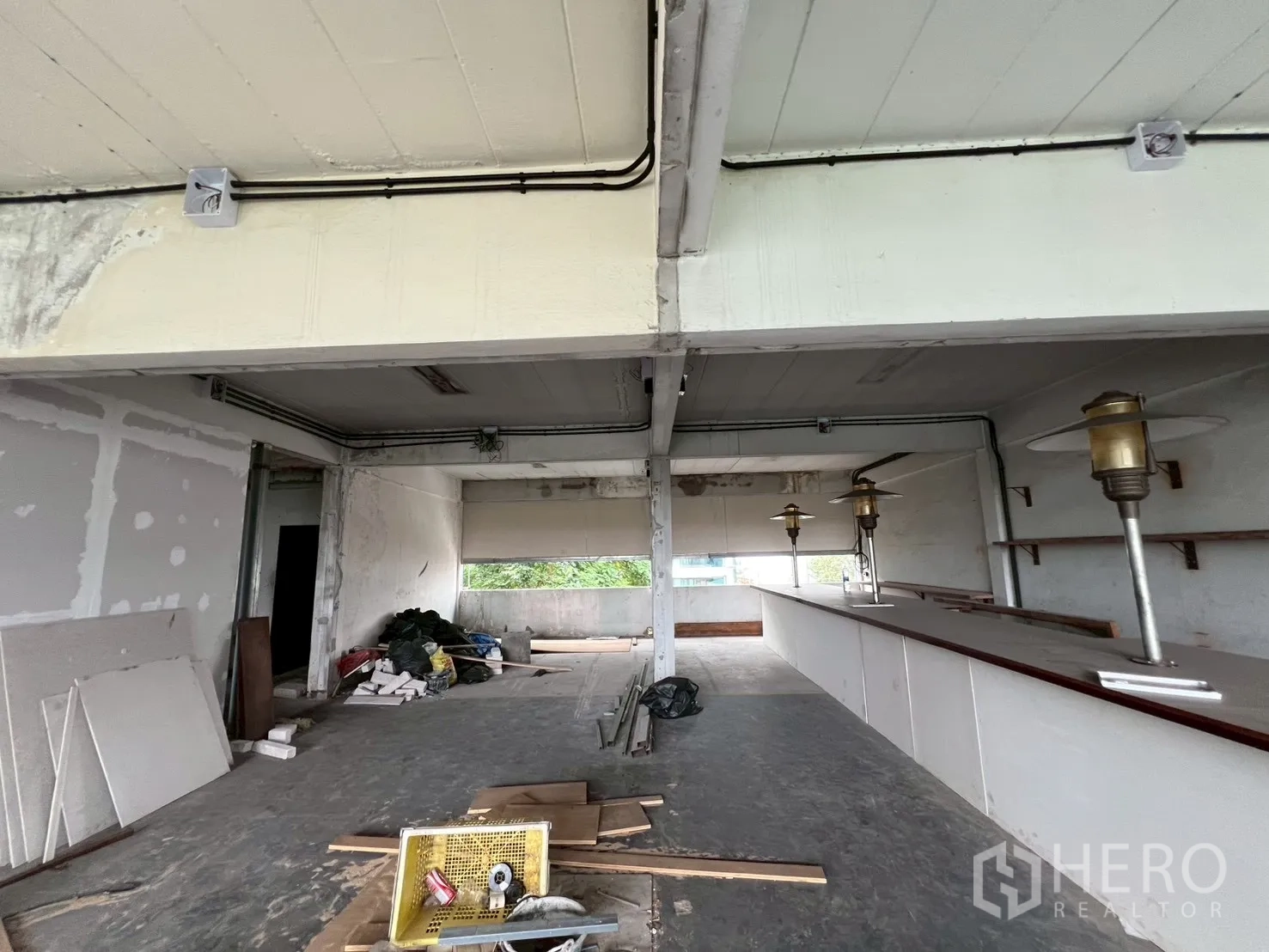 Retail Space for rent in Watthana, Bangkok - Unfinished retail interior with exposed beams, a bar counter and flexible floor area ready for fit-out.