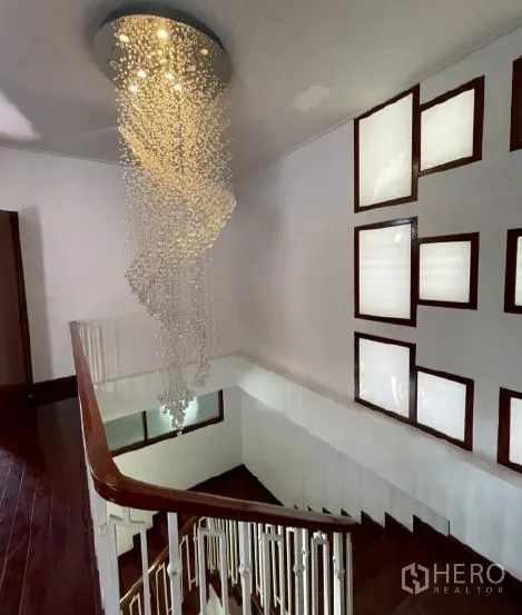 Home Office for rent in Watthana, Bangkok - Staircase with a crystal chandelier and decorative square light windows.
