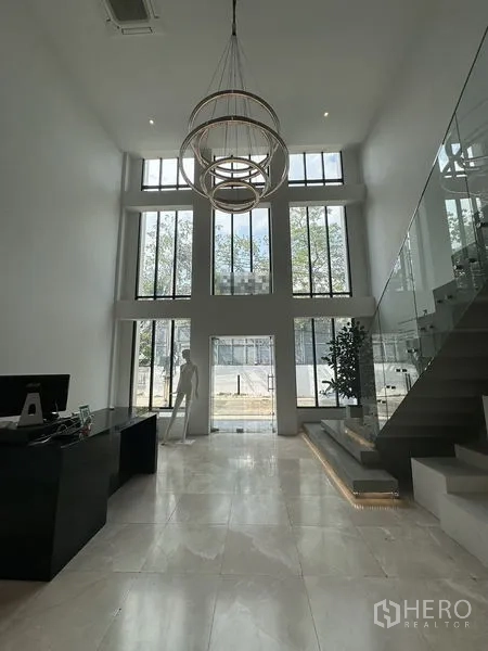 Home Office for rent in Phra Khanong, Bangkok - Grand double-height lobby with marble floors, modern chandelier and glass stair.
