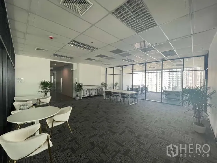 Office Space for rent in Bang Kapi, Bangkok - Open-plan office with lounge tables, potted plants, glass-walled meeting area, and city views.