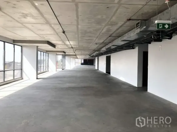 Office Space for rent in Suan Luang, Bangkok - Long rectangular office floorplate with large side windows, concrete floor, and ceiling-mounted services.