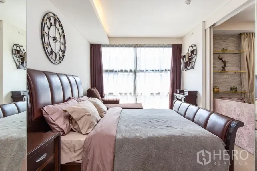 Condominium for rent in Watthana, Bangkok - Bedroom with leather headboard, large window and soft daylight