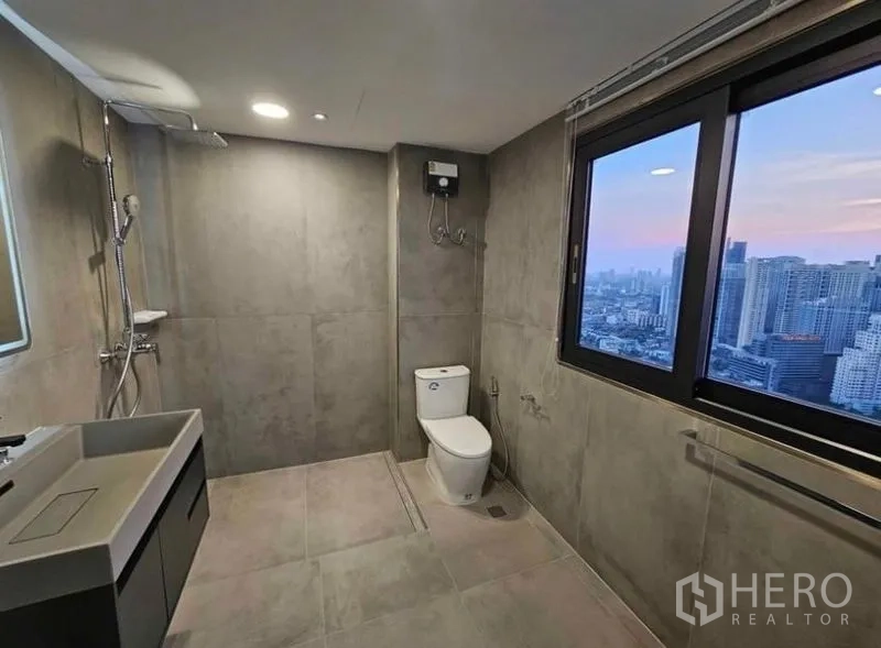 Condominium for rent or sale - Bathroom with window city view, rain shower and sleek vanity.