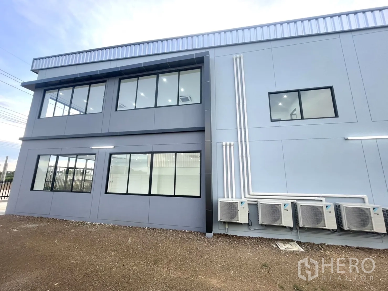 Factory for rent or sale in Bang Yai, Nonthaburi - Side elevation with large windows and outdoor AC compressor units.