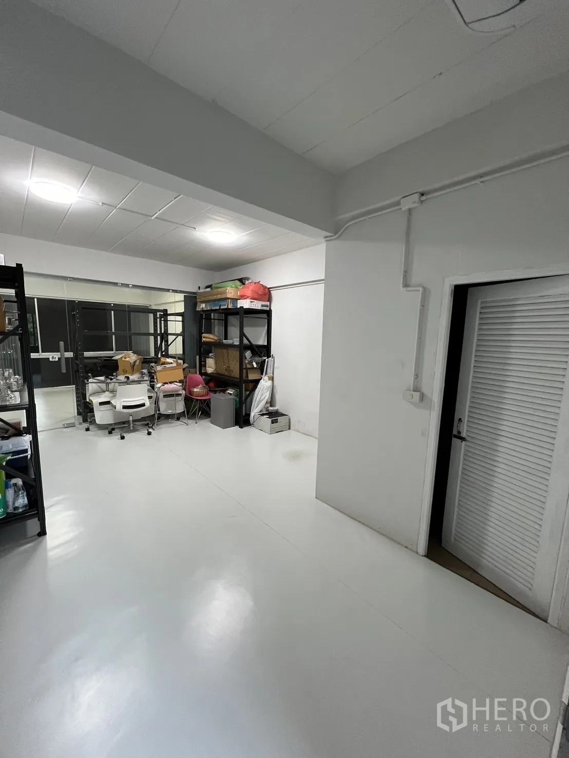 Shophouse for rent or sale in Watthana, Bangkok - Utility or storage room with metal shelving and white flooring.