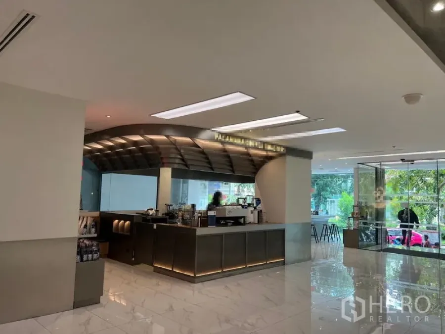 Retail Space for rent in Bang Rak, Bangkok - Modern lobby retail counter with stainless bar, marble floors and glass entrance near BTS Surasak in Bang Rak.