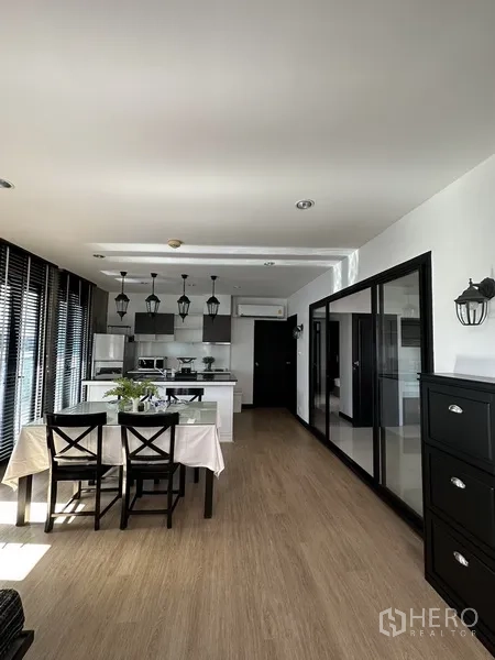 Condominium for rent in Khlong Toei, Bangkok - Bright open-plan dining and kitchen with island and pendant lights.