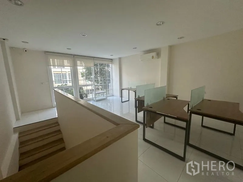 Home Office for rent in Bang Na, Bangkok - Open workstation area on upper level with desks and balcony glazing.