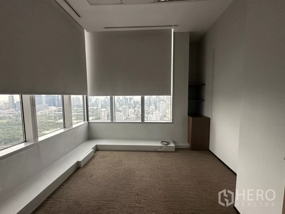 Office Space for rent in Watthana, Bangkok - Corner office with roller blinds and panoramic city skyline views.
