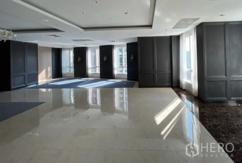Office Space for rent - Large open-plan area with black wall panels, sheer curtained windows and polished tiles.