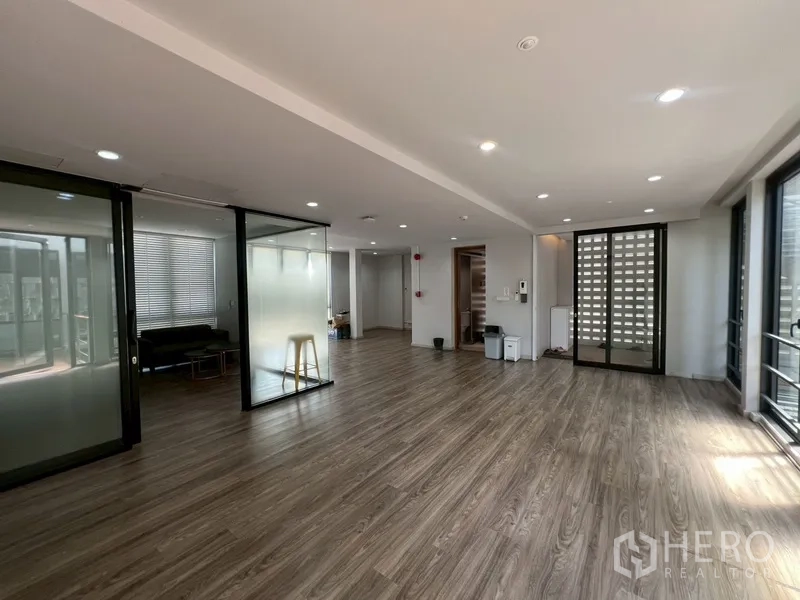 Home Office for rent or sale in Phra Khanong, Bangkok - Open office floor with wood vinyl, recessed lights and glass partitions.