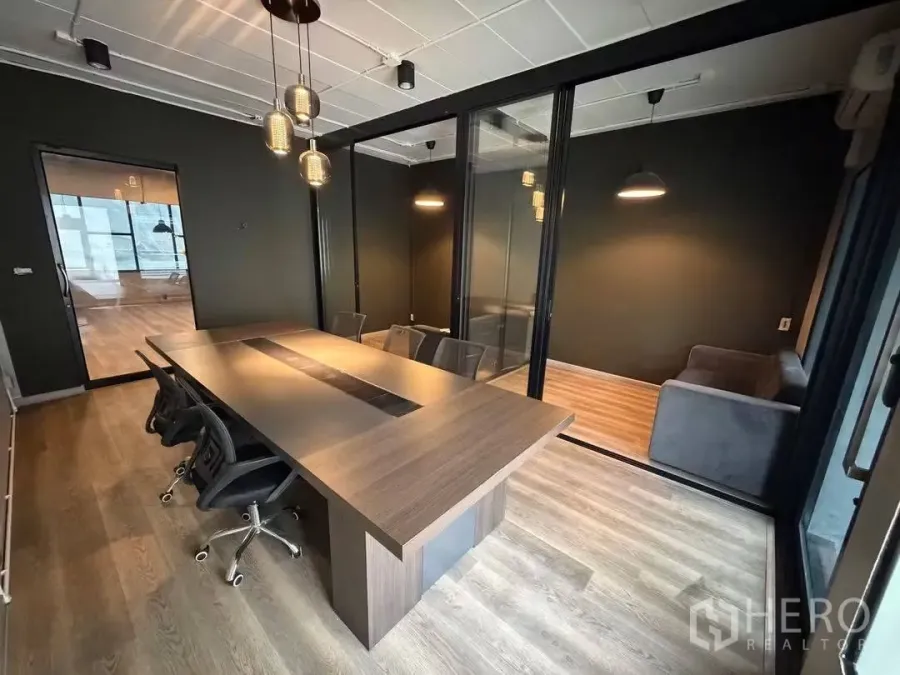 Home Office for rent in Watthana, Bangkok - Glass-partition meeting room with long conference table, chairs and pendant lights.
