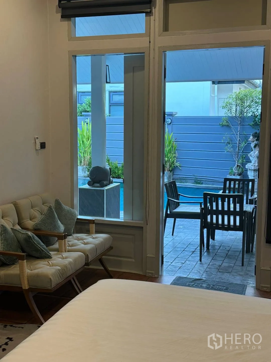Detached House for rent in Watthana, Bangkok - Bedroom seating area and doorway to outdoor dining and pool.