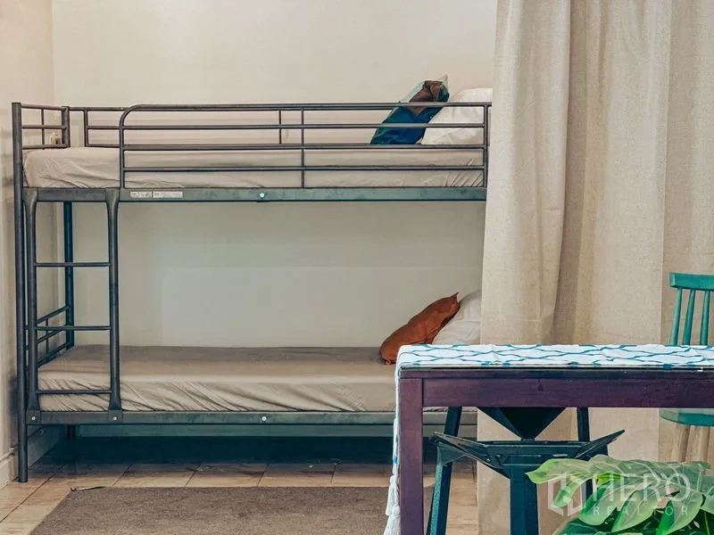 Home Office for rent in Watthana, Bangkok - Metal bunk bed set against a light wall near the dining table.