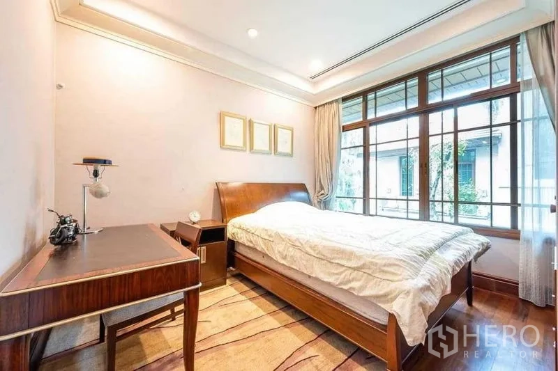 Detached House for sale - Bright guest bedroom with wooden bed, study desk and garden-facing window.