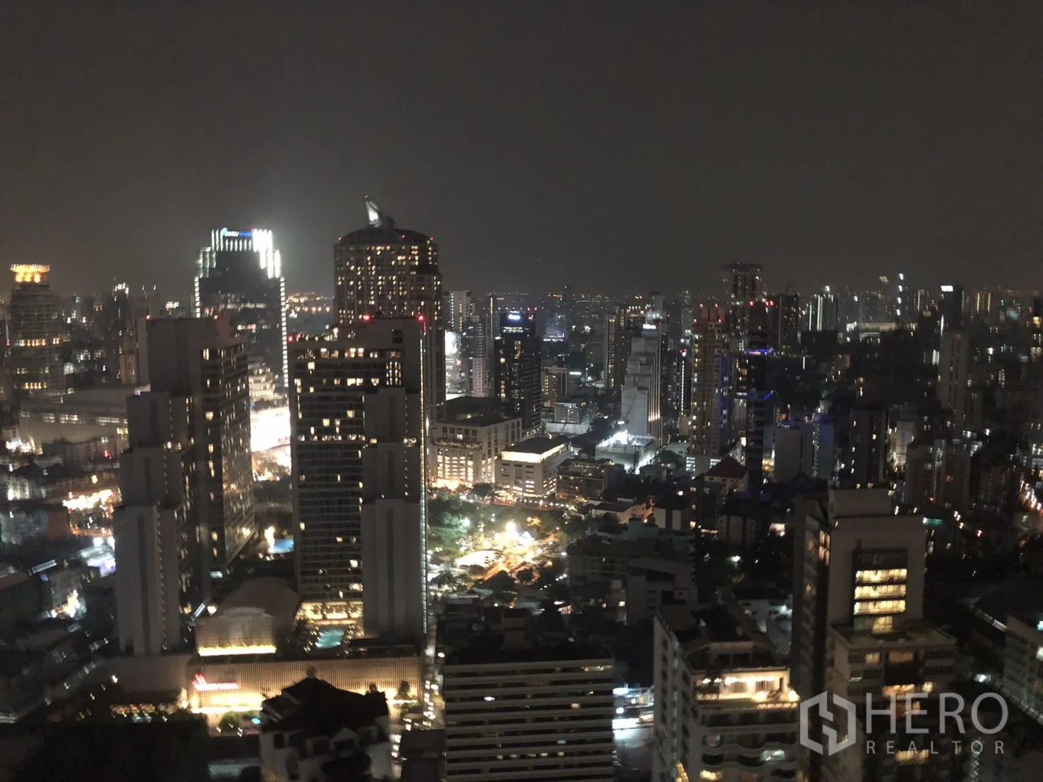 Condominium for rent or sale in Khlong Toei, Bangkok - Night view of Bangkok city skyline from a high-floor condominium window.
