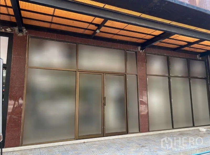 Retail Space for rent in Watthana, Bangkok - Street-level shopfront with wide frosted glass panels and double doors under an awning.