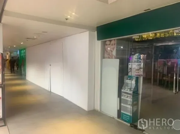 Retail Space for rent - Retail shopfront location beside a glass-fronted store within a covered shopping passage.