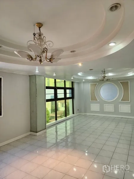 Office Space for rent or sale in Khlong Toei, Bangkok - Bright lobby or meeting room with chandeliers, white tiled floor, and decorative wall paneling.