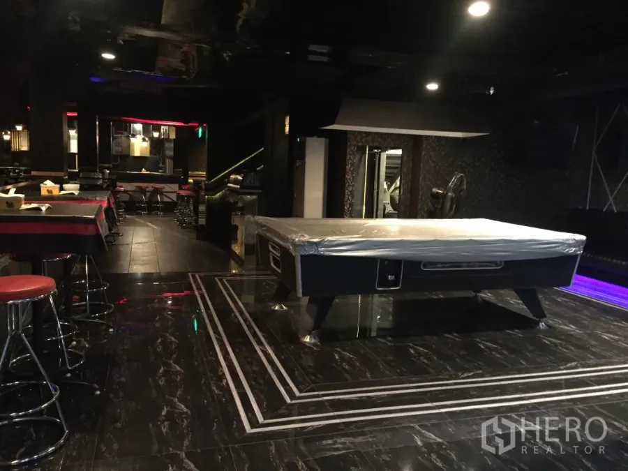 Retail Space for rent in Watthana, Bangkok - Entertainment room with covered pool table, bar seating and glossy dark flooring.