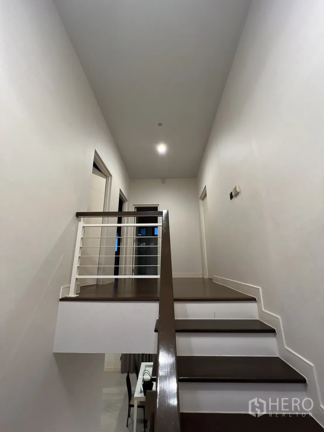 Detached House for rent or sale in Bang Kapi, Bangkok - Upper landing with pendant lights and tall window.